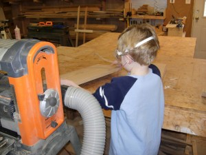 Adam takes the legs from the planer when they come out