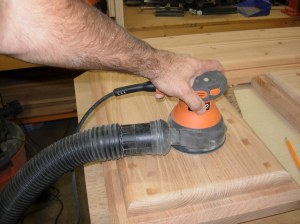 Sanding down the dried wood filler