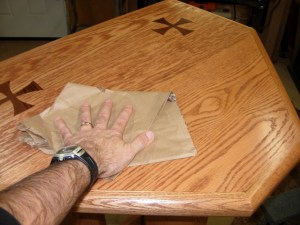 Polishing the finish with a brown paper bag