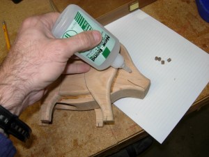 Applying the glue for the eyes and nose