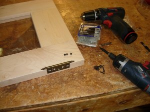 Attaching the hinges to the doors