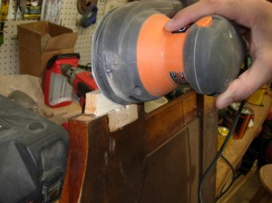 Sanding the shim to fit snug