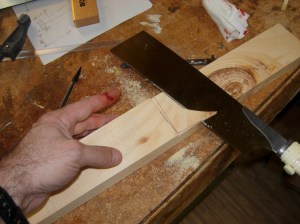 A shallow flush cut on the wood and a deep one on the finger