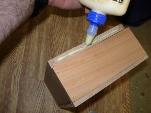 Applying glue to the edge of the lid