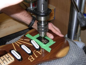 Drilling through holes for the strings