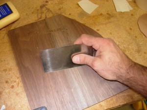 Using a card scraper to blend the seam