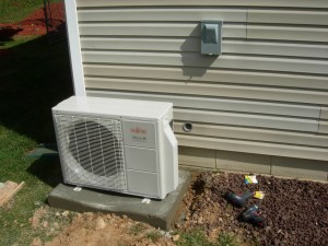 Heat pump set in place and hole cut in outer wall