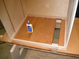 Glue applied to the inner facing edges of the frame