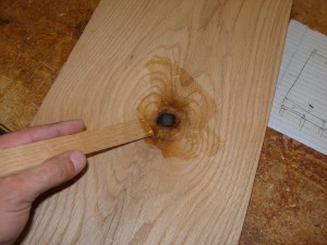 Filling a knot hole in the lower door panel