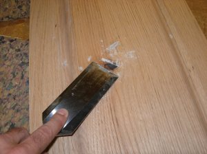 Scraping away the excess epoxy