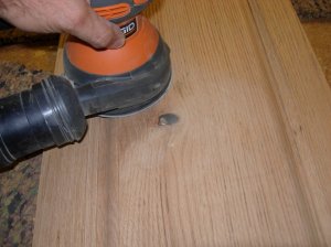 Sanding the scraped surface