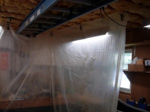 Hanging plastic for a temporary spray booth