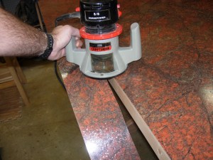 Flush trim bit in a router to trim away the excess