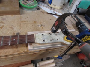 Press-fitting the tuner bushings