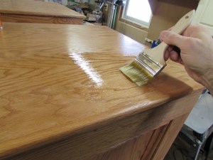 Brushing a third coat on the tops