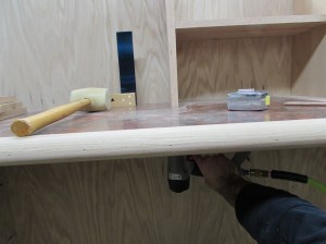 Tacking the verticals in place with brad nails