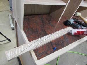 Applying glue to the back of the trim