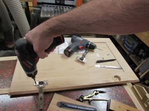 Attaching the hinges to the door panel