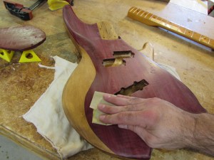 Sanding down the first coat with 400 grit paper